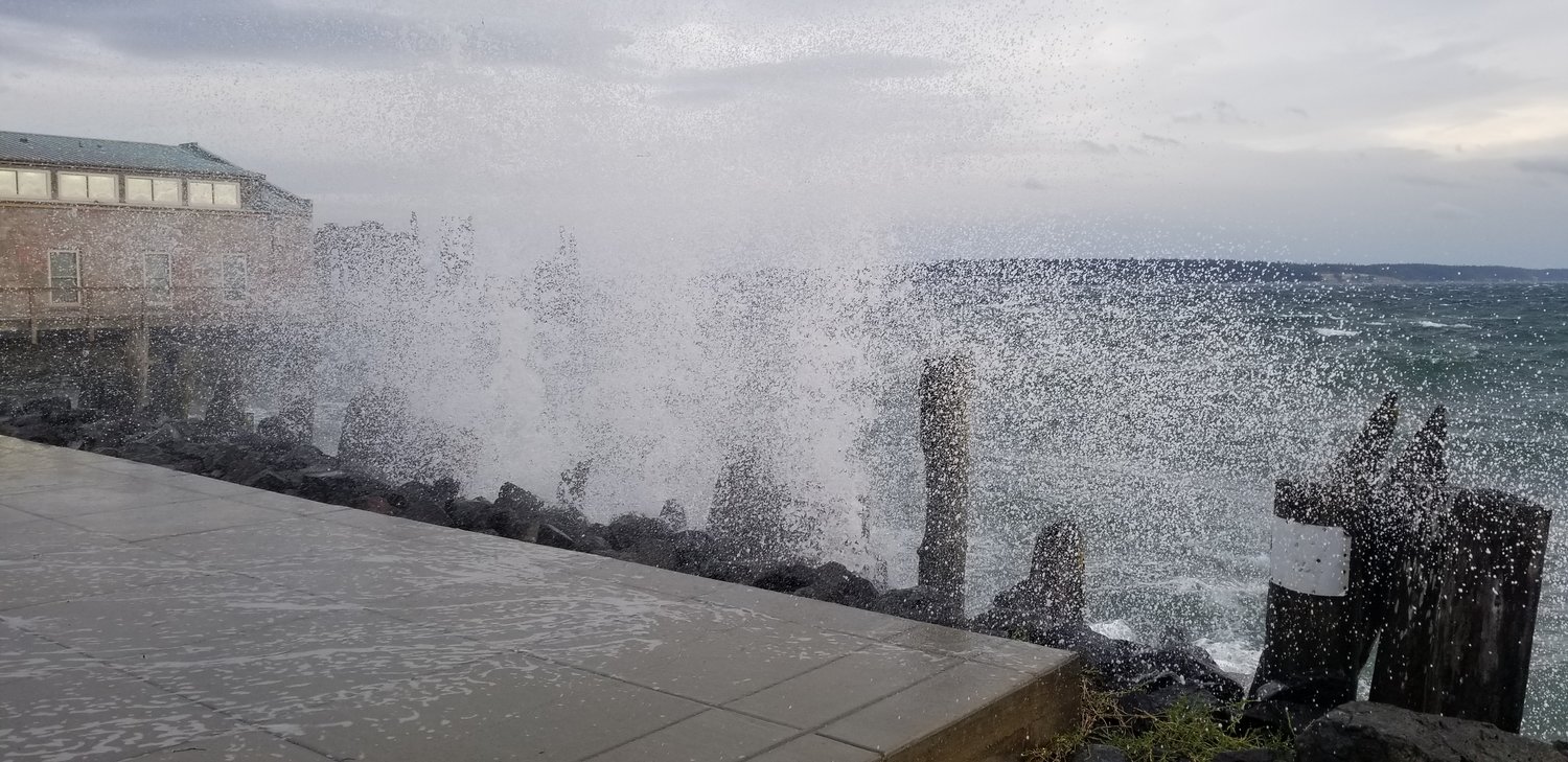 Heavy waves crash ashore in front of Vintage wine bar in Port Townsend